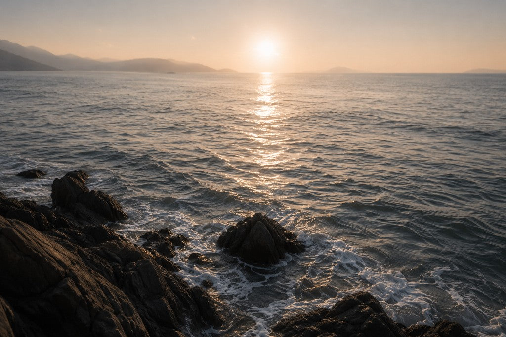 Ocean waves on rocky coastline at sunset